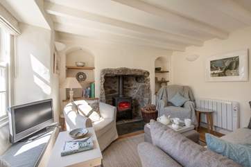 The sitting/dining-room with a roaring wood-burner.