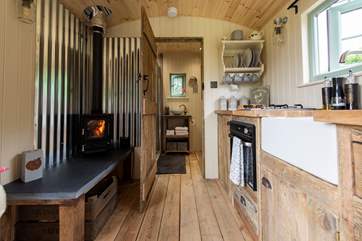 Looking down through the hut to the bespoke, beautifully fitted shower-room, the kitchen has a cute oven with two ring hob and a fridge/freezer too.