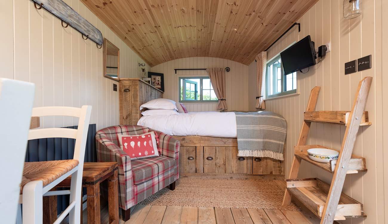 The Hypnos king-size bed offers a blissful night's sleep. With two windows looking out over the meadow, ponds and countryside beyond.
