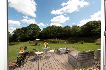 Looking out through the double doors to the deck and pond beyond.