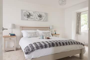 The large master bedroom with calm tones (Bedroom 4).