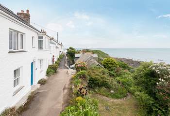 The path to the front of this lovely cottage leads you down to the pub, village shops, cafe and of course the beach in the bay.
