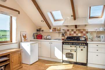 The well appointed kitchen is wonderfully light and airy.