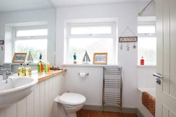 Spacious family bathroom equipped with bath and shower over.