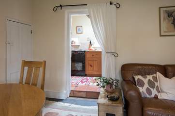 The kitchen-area leads off the sitting-room and up a small step.