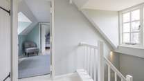 The stairs wind up from the ground floor, through the first floor and deliver you on the hallway on the second floor.