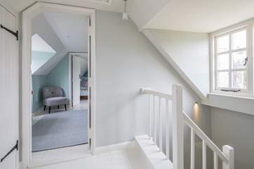 The stairs wind up from the ground floor, through the first floor and deliver you on the hallway on the second floor.