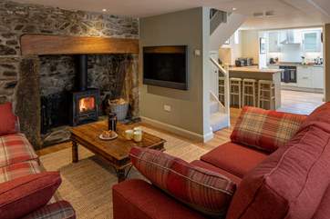 Looking through to the kitchen, past the Bang & Olufsen TV. No expense has been spared in this beautiful cottage.