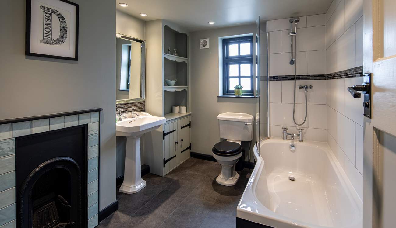 The family bathroom boasts a lovingly restored fireplace. What a stunning piece of history.
