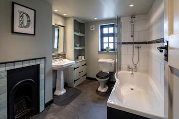 The family bathroom boasts a lovingly restored fireplace. What a stunning piece of history.