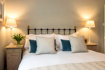 Beautiful cushions and Atlantic Blanket throws adorn the bed.