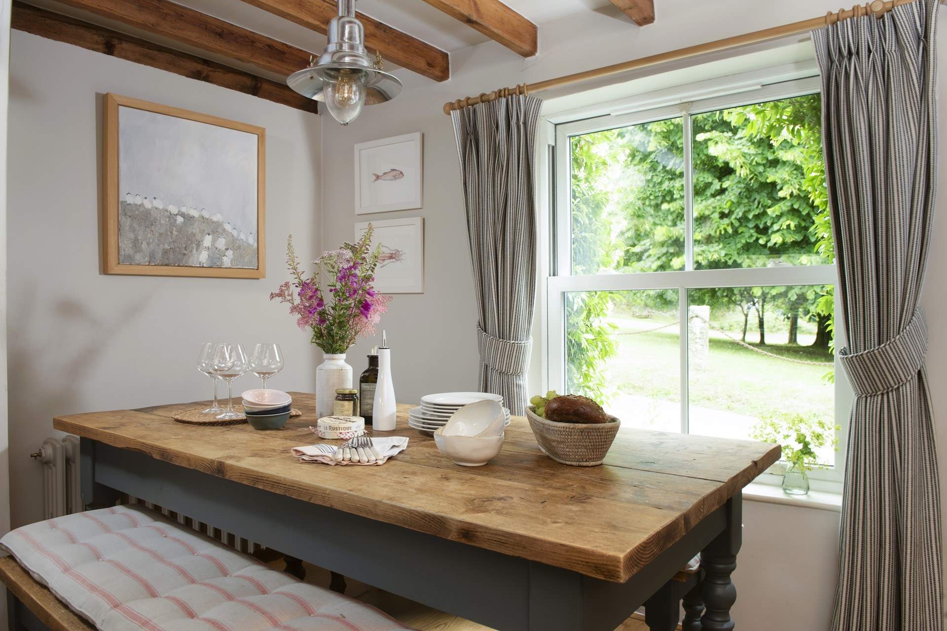 The dining-table enjoys views over the church green.