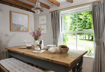 The dining-table enjoys views over the church green.