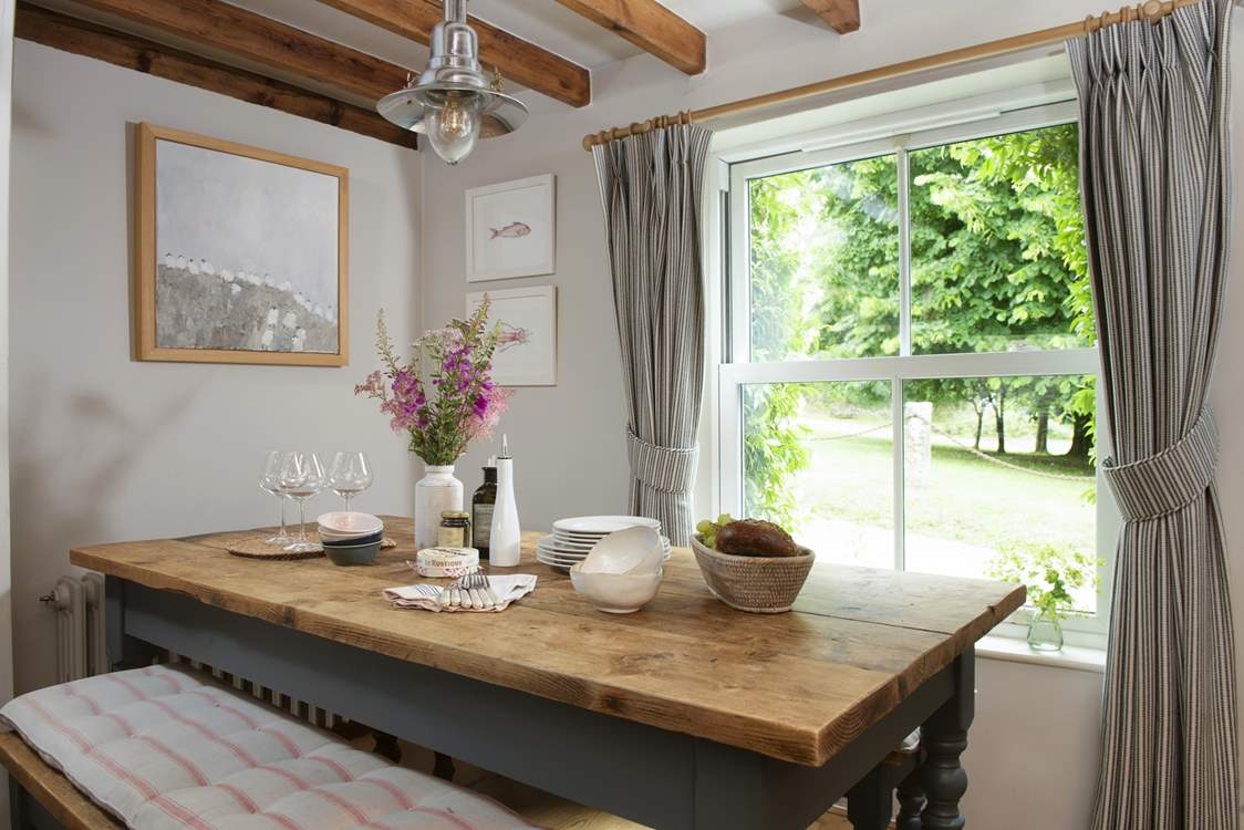The dining-table enjoys views over the church green.