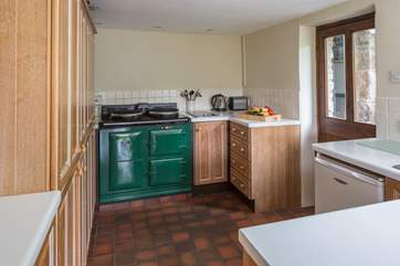 The fully equipped kitchen is complemented by the delightful electric Aga.