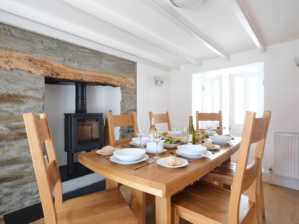 Gather everyone around the table to chat about the days adventures. The wood-burner is decorative only and not for guests use.
