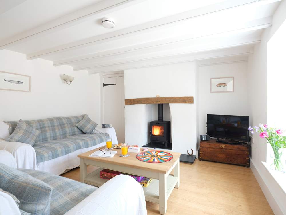 The sitting-room has a cosy wood-burner.