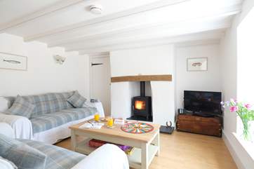 The sitting-room has a cosy wood-burner.