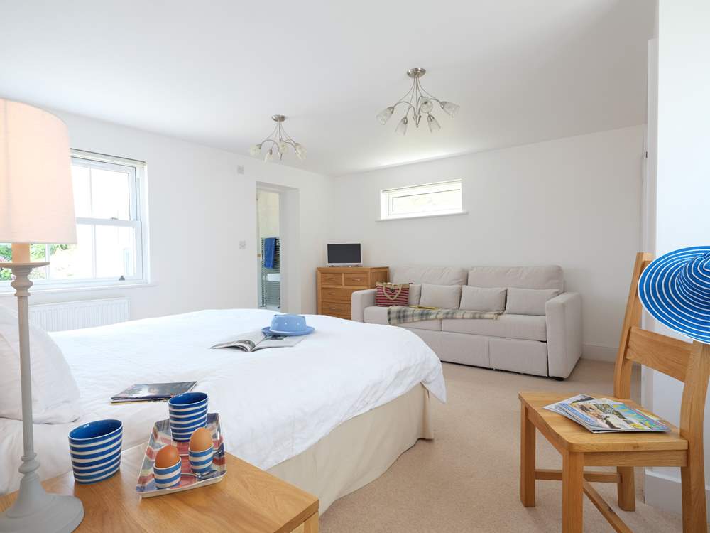 Bedroom 1 the spacious master bedroom has a sofa.