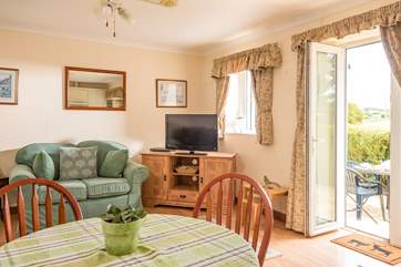 Room to relax and dine with doors straight out onto the patio terrace.