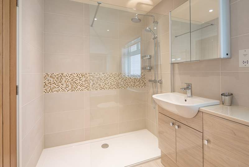 Located at the foot of the stairs is the family bathroom. Equipped with a large walk-in shower along with a bath, WC and wash-basin.