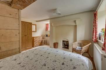 Another view of the ground floor bedroom with its ornamental feature fireplace.