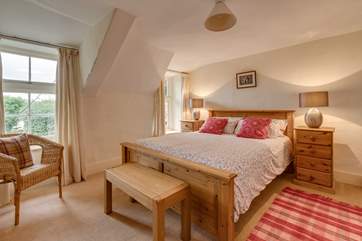 This is the master bedroom on the first floor. The room looks out to the front of the cottage.