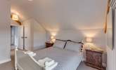 The main bedroom has a king-size bed and its own en suite shower-room. High ceilings and a large window make this room lovely and light and airy. - Thumbnail Image