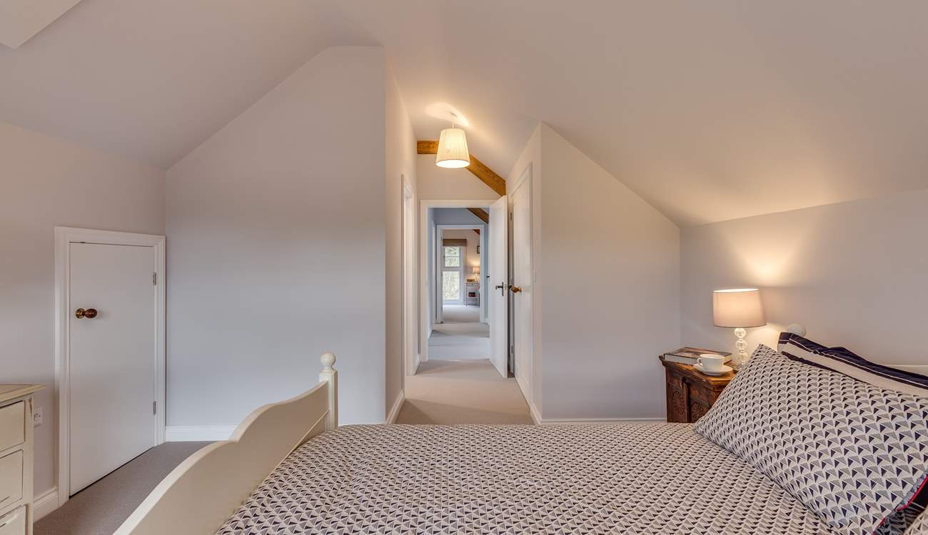 The two bedrooms are at opposite ends of the corridor.