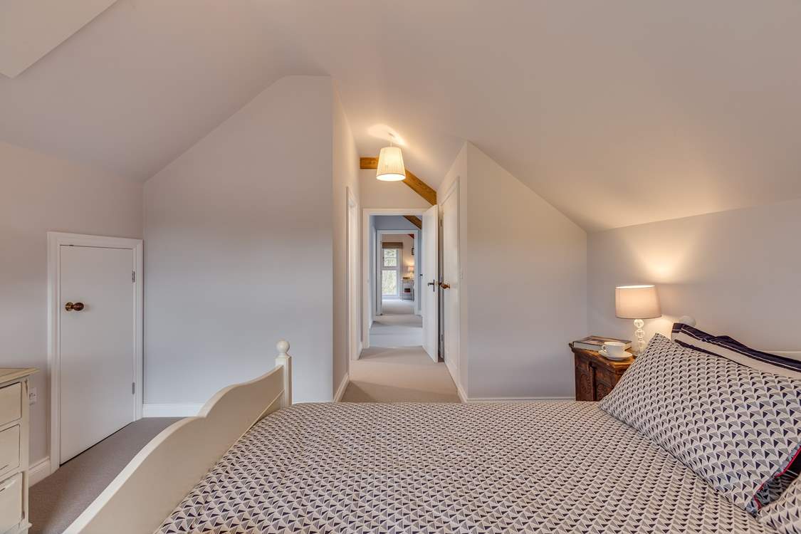 The two bedrooms are at opposite ends of the corridor.