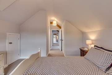 The two bedrooms are at opposite ends of the corridor.