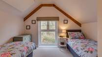 The second bedroom has views out over the 2.5 acre arboretum which is filled with unique tree species.