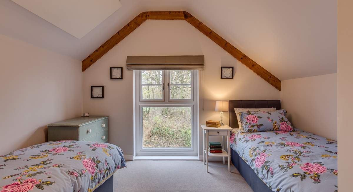 The second bedroom has views out over the 2.5 acre arboretum which is filled with unique tree species.