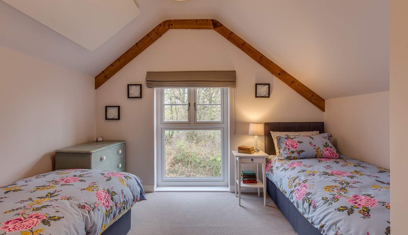 The second bedroom has views out over the 2.5 acre arboretum which is filled with unique tree species.