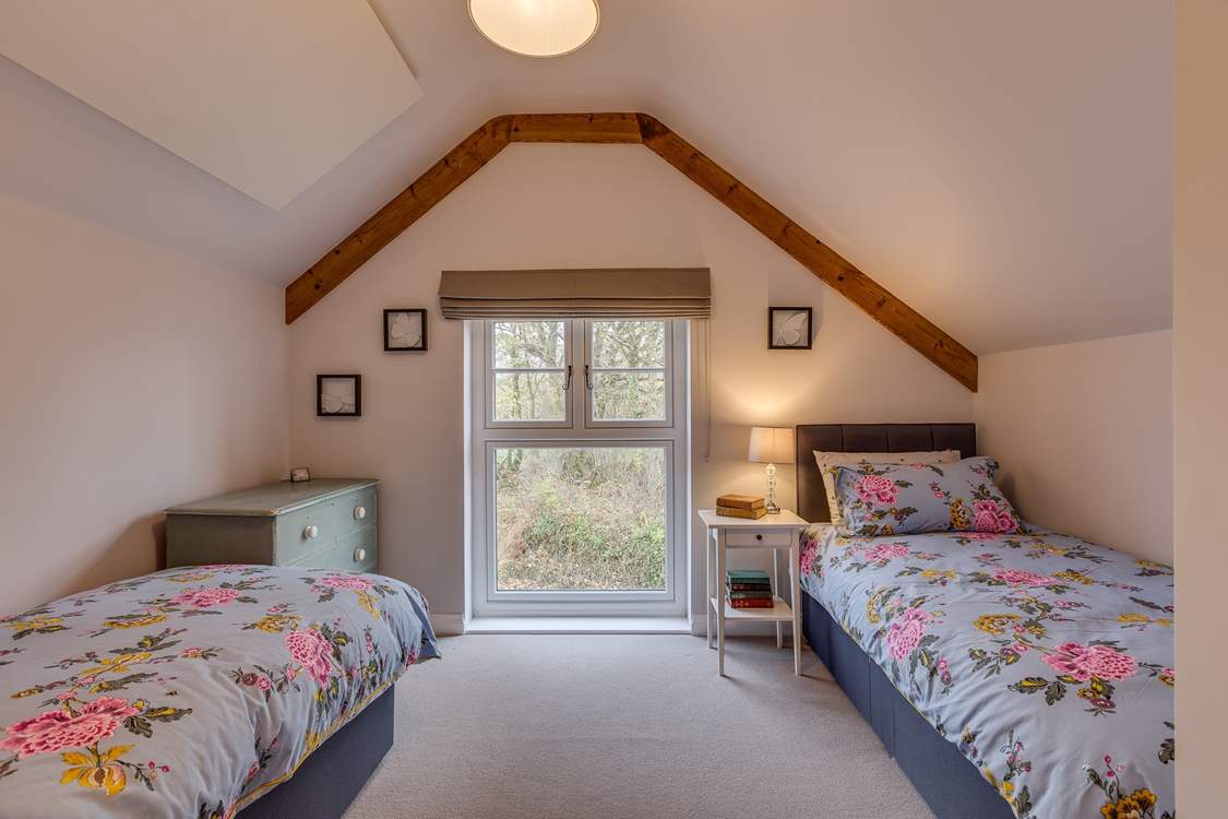 The second bedroom has views out over the 2.5 acre arboretum which is filled with unique tree species.