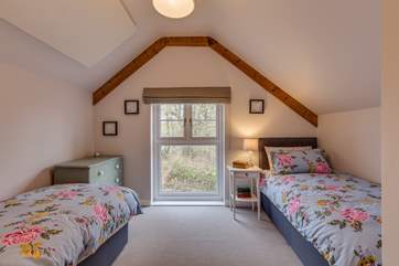 The second bedroom has views out over the 2.5 acre arboretum which is filled with unique tree species.
