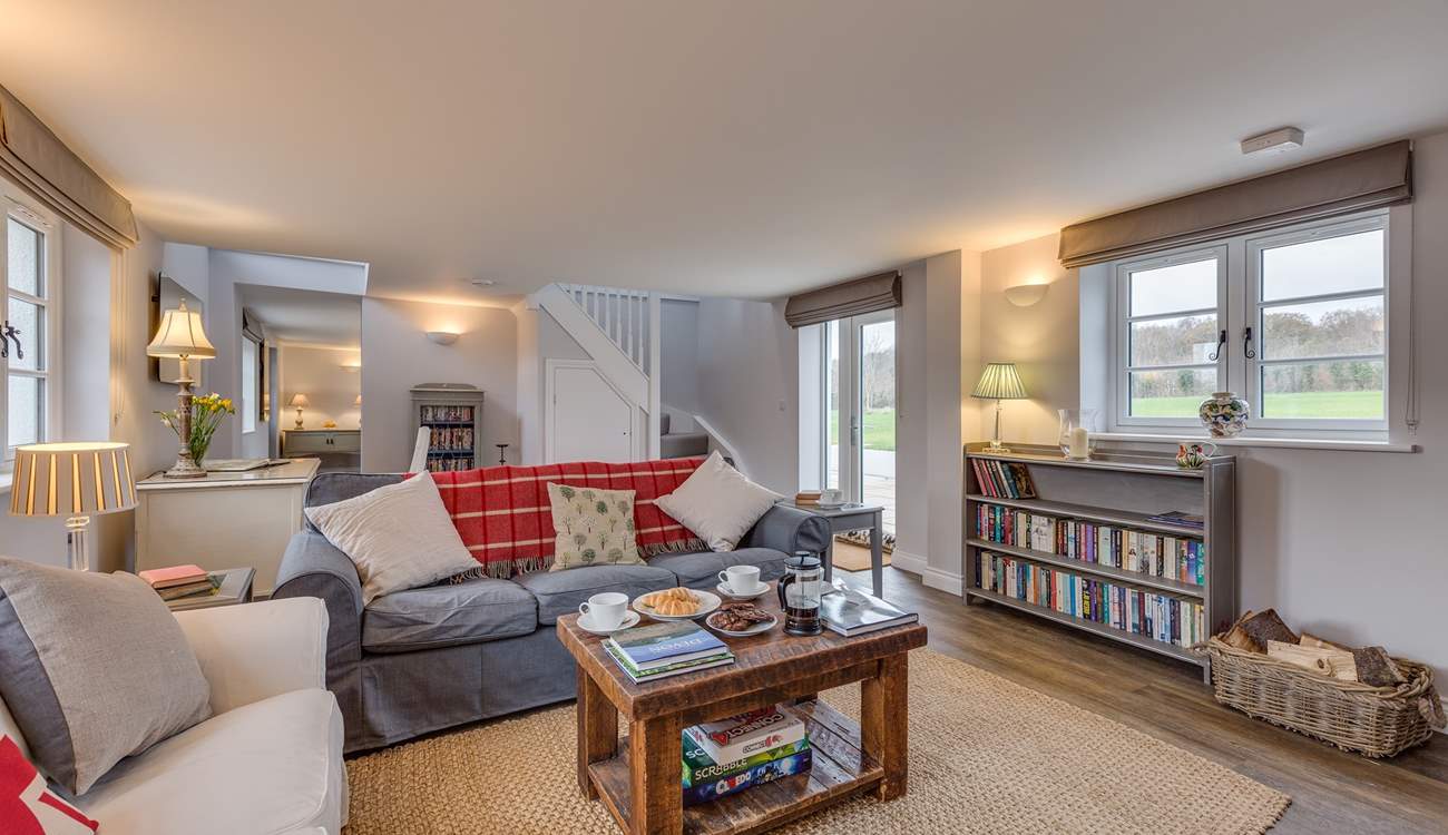 Stairs lead from the sitting-room to the first floor of the cottage. There is also a door directly out onto the patio. 