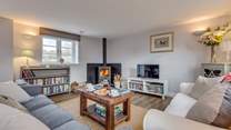 The sitting-room has a wood-burning stove and deep comfy sofas to curl up on.