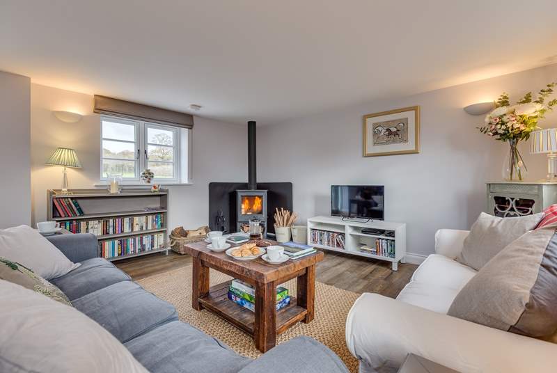 The sitting-room has a wood-burning stove and deep comfy sofas to curl up on.