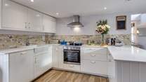 The kitchen is a delightful sociable space to cook in, with the farmhouse table in the other half of the room.