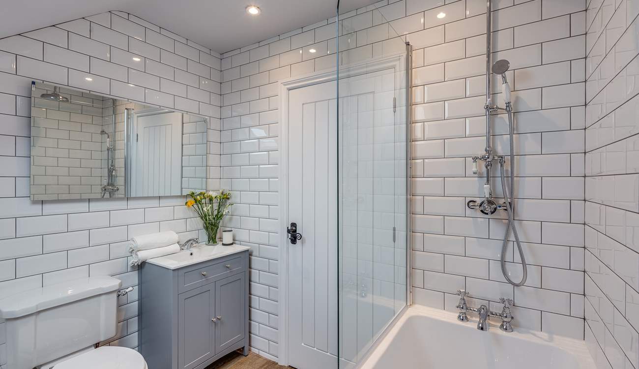 The bathroom next to the twin bedroom has a bath as well as a fitted shower.