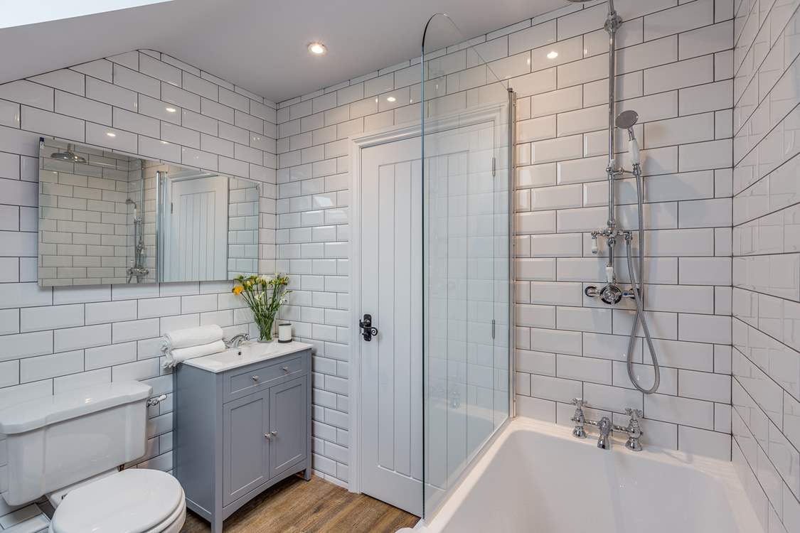 The bathroom next to the twin bedroom has a bath as well as a fitted shower.