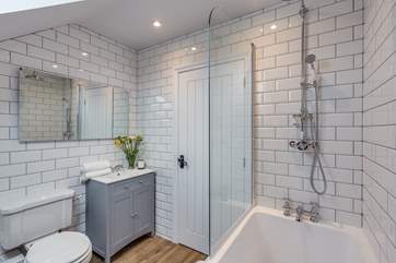 The bathroom next to the twin bedroom has a bath as well as a fitted shower.