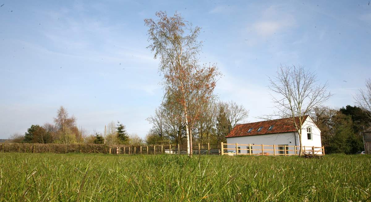 Crab Apple Cottage at Daisyland Farm - with a large enclosed garden and open views over the field to the woodland beyond.