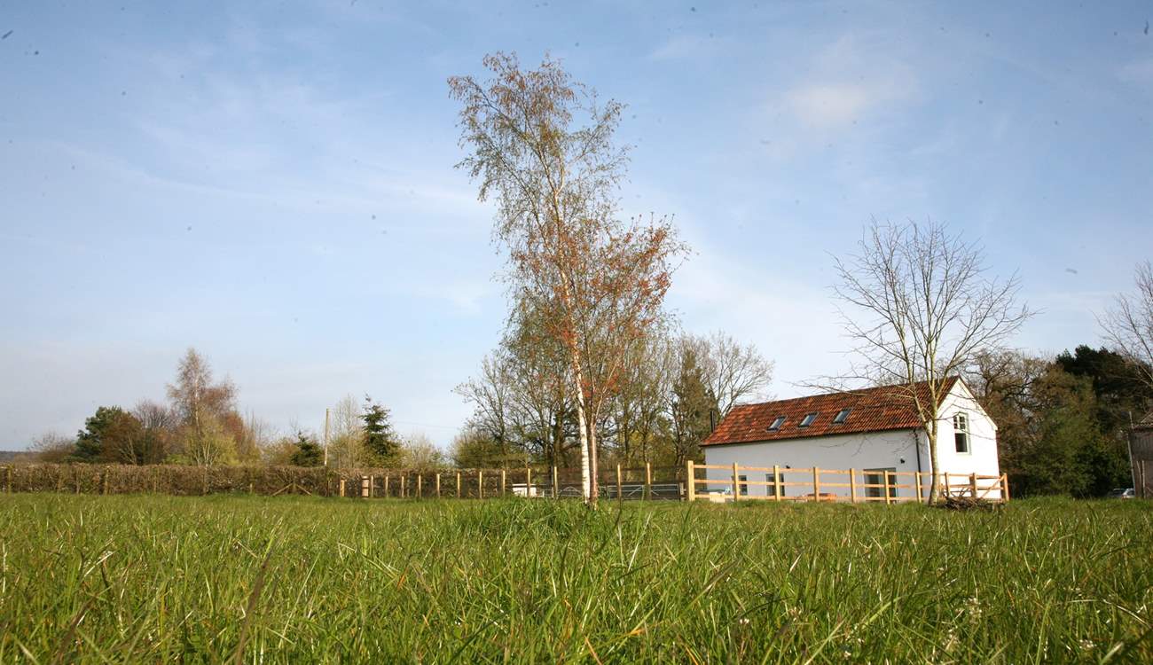 Crab Apple Cottage at Daisyland Farm - with a large enclosed garden and open views over the field to the woodland beyond.