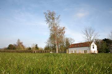 Crab Apple Cottage at Daisyland Farm - with a large enclosed garden and open views over the field to the woodland beyond.