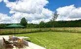 Two sets of doors open onto this wide paved terrace and the fully enclosed garden. The post and rail fencing also has rabbit proof wire and so is as secure as is reasonably possible. - Thumbnail Image