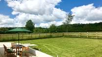 Two sets of doors open onto this wide paved terrace and the fully enclosed garden. The post and rail fencing also has rabbit proof wire and so is as secure as is reasonably possible.