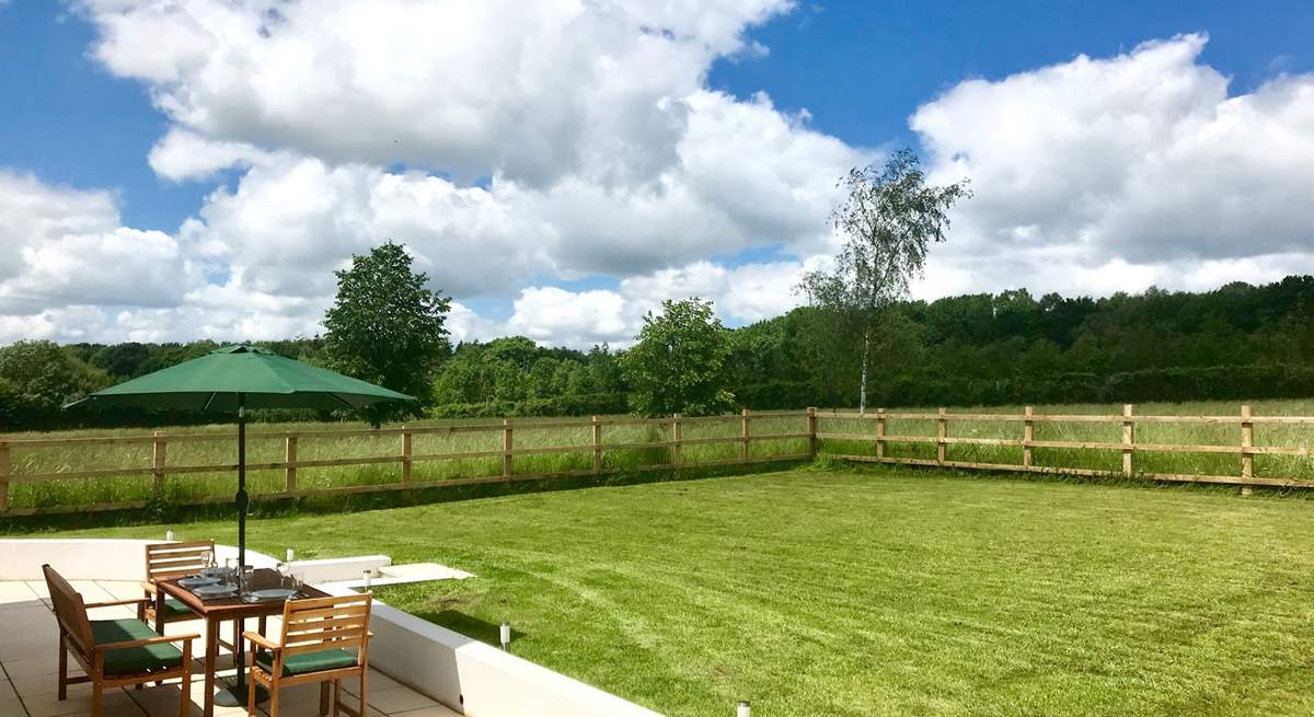 Two sets of doors open onto this wide paved terrace and the fully enclosed garden. The post and rail fencing also has rabbit proof wire and so is as secure as is reasonably possible.