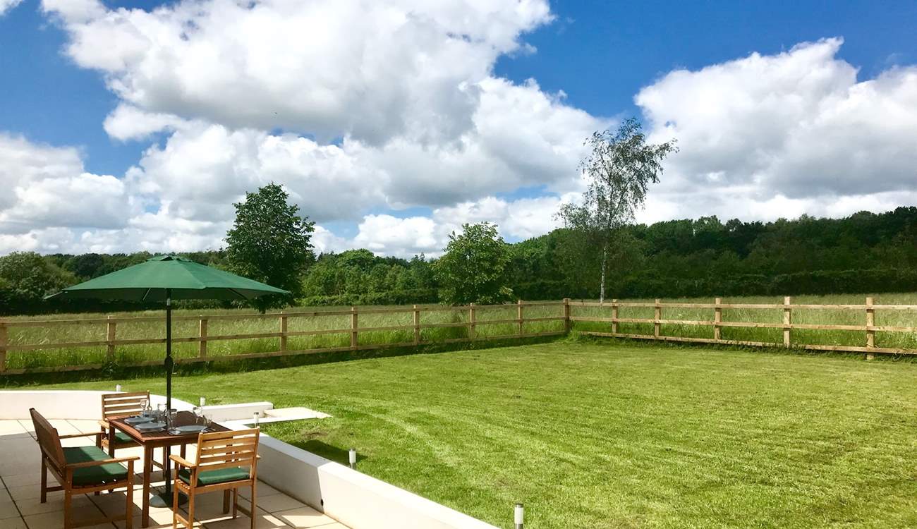 Two sets of doors open onto this wide paved terrace and the fully enclosed garden. The post and rail fencing also has rabbit proof wire and so is as secure as is reasonably possible.